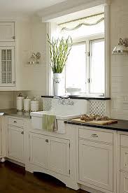 This kitchen designer used a light grey shaker cabinet design for a subtle pop of contrast against the shimmery white herringbone backsplash. Shaker Cabinets Apron Sink Simple Farmhouse Kitchen Kitchen Inspirations Farmhouse Kitchen Cabinets
