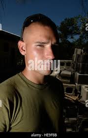 Air Force 2nd Lt. Robert Pahissa (left) is congratulated by retired Air  Force Col (Dr.) Jessica Servey (right), as she gets ready to present him  with his traditional medical school white coat