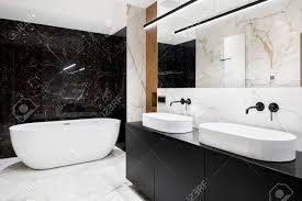 H single bathroom vanity in antique white with black quartz top (1) stephenson 33 in. Luxury Bathroom With Black And White Marble Tiles On Walls And Floor And Big Oval Bathtub Stock Photo Picture And Royalty Free Image Image 143510910