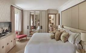 The cool beige wall color harmonizes with warmer tones featured in the natural wood window panes and various accessories throughout the room. Neutral Bedroom Ideas Neutral Bedroom Colours Luxdeco