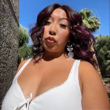 Hopi potter Bobby Silas holding the coal-fired, Sikyátki-inspired jar that  is the newest addition to ASM's collections. Depicted