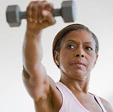 Menopausal woman exercising with dumbel