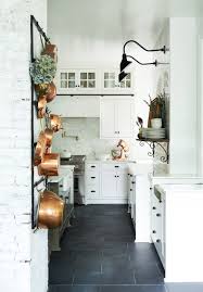 The dark brown wooden floor, black chair, and white tables. The Donley Project Leanne Ford Small White Kitchens Dark Kitchen Floors Country Chic Kitchen