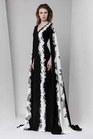 Black And White Evening Gowns With Sleeves Black And White Sheath Moroccan Crepe Dress Featuring A V Neckline Floor Length Sleeves And Lace Em With Images Formal Evening Dresses White Evening Dress Evening Dresses