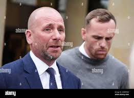 Alan Johns (left) and Grant Johns, the father and brother of Finlay Johns,  speak to the media outside the High Court in Glasgow, where Jake Loy, 19,  who killed three friends in
