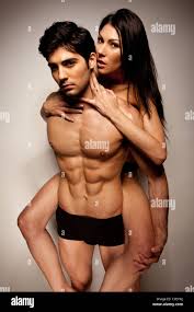 Sexy Woman Riding Piggyback on the back of a handsome young man in ...