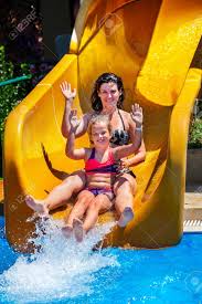 From trendy flamingo swimming pools to kiddie pools with slides, there's bound to be an option on our list that will work for your family! Swimming Pool Slides For Family With Children On Water Slide Stock Photo Picture And Royalty Free Image Image 74615616