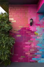 A Residential Home Has Been Used As A Giant Art Canvas With A Vibrant Abstract Design Painted On Th Brick Wall Background Wall Background Home Remodeling Diy