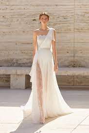 Spring 2021 Trend Alert Asymmetrical Wedding Gowns In 2021 Wedding Gown Trends Wedding Dress Trends Wedding Dresses