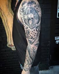 Our artists specialize in all genres of tattooing including black and gray, photorealism, american traditional, japanese, and biomechanics in addition to many other styles. Black Traditional Sleeve Novocom Top