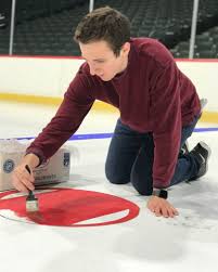 A late, cold night with the painstaking task of painting the Wild's ice