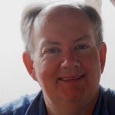 What is the name of the road in the historic photograph of Adamsville?