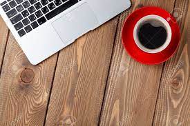 Squeeze in work between coffee breaks. Office Desk Table With Laptop Computer And Coffee Cup Top View With Copy Space Stock Photo Picture And Royalty Free Image Image 43447922