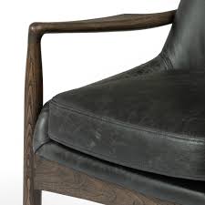 A sculpted frame adds an architectural feel to the soft, light camel upholstery. Braden Leather Dining Arm Chair Durango Smoke