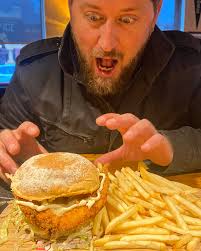 San Antonio Bean Burger (The burger with the magical fruit) Beef burger  with mayo, refried (pinto) beans, cheezewhiz and corn chips! All the food  groups!! Paul likes it