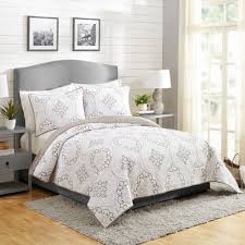 A bedspread drapes all the way to the floor for total coverage that fully encompasses a bed, giving it a formal look. Gray Modern Bedding Target