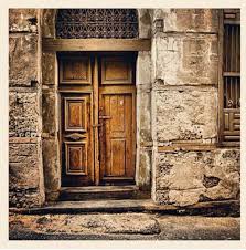 This slender black door springs from a white home, surrounded by matching wrought iron fencing. House Door Old Jeddah Old Jeddah Architecture Drawing Art Rustic Doors