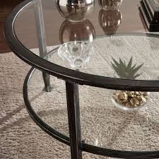 A wood and metal coffee table with a sleeka wood and metal coffee table with a sleek glass display compartment. Southern Enterprises Jaymes Black Metal And Glass Round Cocktail Table Ck8740 Bellacor In 2021 Round Metal Coffee Table Round Glass Coffee Table Coffee Table