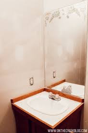 Once the escutcheon is free from the wall, slide it forward on the grab bar to reveal the screws holding the grab bar to the wall. On The Creek How To Remove A Mirror Glued To The Wall