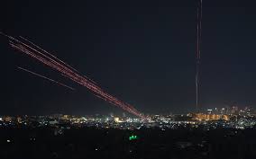 Amid celebratory gunfire, residents who fled Hezbollah's Beirut stronghold start returning after truce takes effect