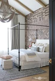 The airy and expansive bed is positioned at the center of the windows and flanked by gorgeous, graphic drapes and twin table lamps. French Style Master Bedroom Ideas Design Corral