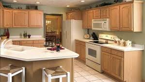 I recommended that they paint the walls a creamy white or pale gold, which would other paint colors that would look beautiful with honey oak wood trim are warm grays with green or bronze undertones. Note How These Wooden Cabinets Look With The Green Wall Paint Not Sure If I Care For These Co Unfinished Kitchen Cabinets Kitchen Colors Kitchen Wall Colors