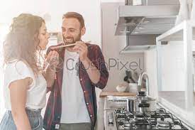 Remember me · forgot password? Beautiful Young Couple Smiles While Tasting The Prepared Food Couple Stock Photo Crushpixel