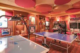 This Game Room Boasts Multiple Arcade Games And A Table Tennis Set Surrounded By Stylish Walls That Match The Cei Arcade Room Game Room Design Arcade Game Room