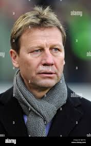 Former National Football League Player Brian DeMarco, center, is helped to  the podium by former players Conrad Dobler, left, and Daryl Johnston during  a news conference explaining the state of affairs for