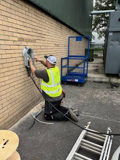 Electrician wiring a home garage energy point in Erith