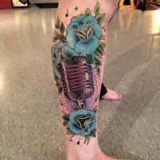 There are bright red roses that are mixed in with a mixed tape as well as a microphone. Fyeahtattoos Com Traditional Microphone And Roses Tattoo Done By