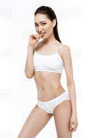 This happens to me sometimes, but it never happened at that age. Elegant Sensual Asian Girl Posing In White Underwear Isolated On White Stock Photo Dissolve