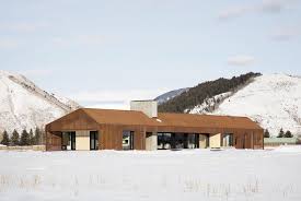 The large overhanging porch functions exactly the same as on the shotgun house: Aeccafe Dogtrot Residence In Jackson Wyoming By Clb Architects