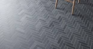 A classic freestanding tub and white cabinets are supported by a bold blue white and black. Honister Slate Tiles Black Neptune