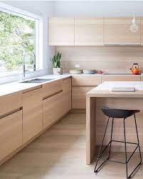 The blonde timber works as both a light accent colour and a source of texture, while the open shelving and island are practical. Dot And Pop Love Me A Light Filled Timber Kitchen Via Bookofdecor Interior Design Kitchen Kitchen Interior Modern Kitchen Cabinets