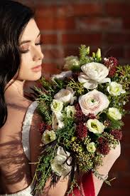 Silk wedding bouquets with runuculus and pine cones. Winter Bridal Bouquets