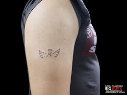 The keep calm monkey tattoo on the neck is a nice way to show your humorous side, the monkey's face looks anything but calm while it wears a cap that says keep calm. Big Guys Tattoo