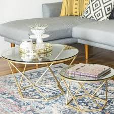 Each serves as a venue to display a collection of books or curios, while providing a convenient spot to rest a mug of coffee or a glass of wine. Everly Quinn Aman 2 Piece Coffee Table Set Base Color Gold Coffee Table Modern Living Room Table Furniture