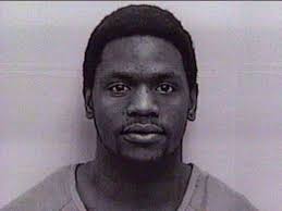 One charged, another wanted for 2002 murder