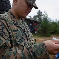U.S. Marine Corps Lance Cpl. Raymond Hsu writes down
