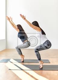 Hatha yoga is a holistic way of achieving the mastery over your body and mind. Zwei Junge Frauen Tun Yoga Asana Stuhl Pose Leinwandbilder Bilder Asana Haltung Barfuss Myloview De