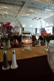 For a rustic theme, incorporate the gold shimmer burlap table runner by placing it on the head table. Black Table Cloth Burlap Linen Runner Jar Candle Centrepiece Wedding Decor Mason Jar Wedding Decor Mason Jar Wedding Candle Jar Centerpieces