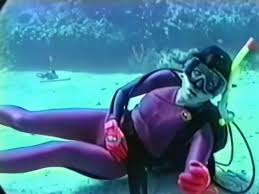 Hot wetsuit girl struggling underwater