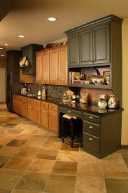 Here, the backsplash is tiled with varying shades of teal to temper the rich wood tones in. What To Do With Oak Cabinets Designed