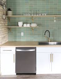 The blue backsplash contrasts with the tone, style, and pattern of the floor tiles, while stainless steel appliances bring modernity to space. 6 Ceramic Tile Ideas For Small Kitchen Backsplashes Small Kitchen Backsplash Modern Kitchen Tiles Small Kitchen