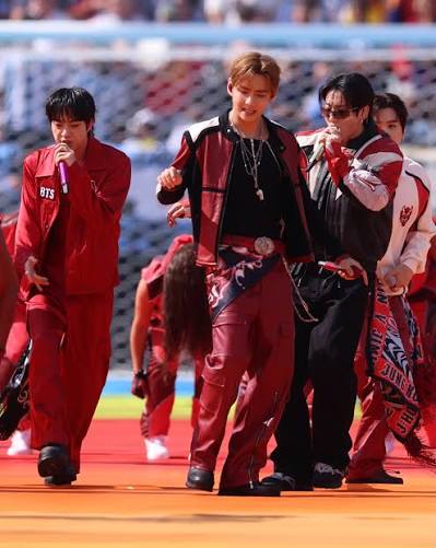 bts.bighitofficial coordinates in red jerseys and customised leather jackets for the halftime show at the FIFA World Cup final in the midst of extensive touring. Image credits: @gettyimages #VogueCulture