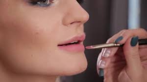 makeup artist using brush for
