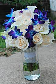 Asiatic lilies, ranunculus and bright blue orchids. Blue Orchid Wedding Bouquet Blue And Purple Orchids Ivory Roses Orchidsbouquet Orchidswedding Blue Orchid Wedding Wedding Flower Guide Blue Wedding Bouquet