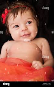 cute infant baby girl with red bow and red tutu Stock Photo