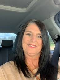 Lady in 60s with salt and pepper hair